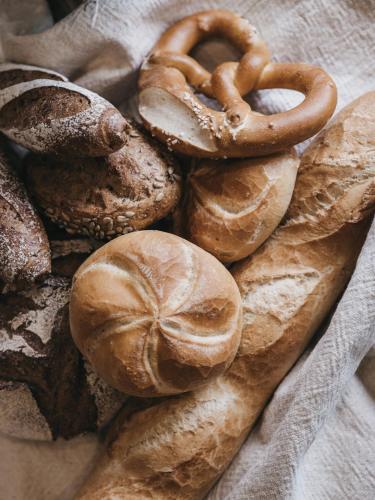 a group of breads and pretzels on a table at VAYA Terrazena Serfaus inklusive Super Sommer Card in Serfaus