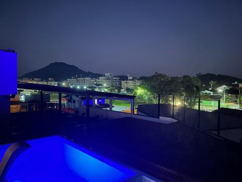 a swimming pool on the roof of a house at night at Pousada do Francês in Ubatuba