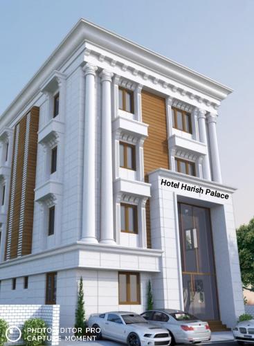 a building with a car parked in front of it at Rameswaram Harish Palace in Rāmeswaram