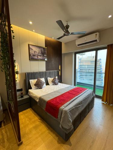 a bedroom with a bed and a large window at Luxury stay by GT Studio in Ghaziabad