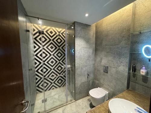 a bathroom with a shower and a toilet at Luxury stay by GT Studio in Ghaziabad