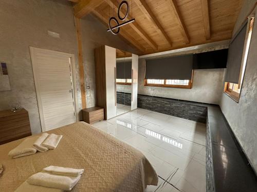 a bedroom with a bed with two towels on it at Testa House in Catania