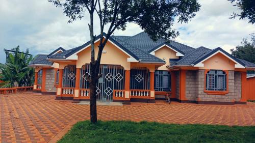 a house with a brick driveway in front of it at Muringa Villa in Nyeri