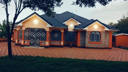 a house with a brick driveway in front of it at Muringa Villa in Nyeri