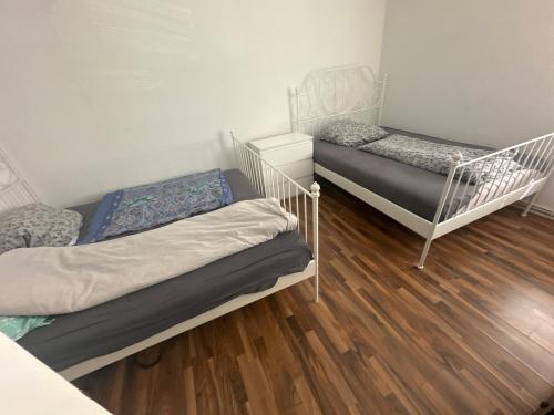 two bunk beds in a room with wooden floors at Monteuren Wohnung in Hannover