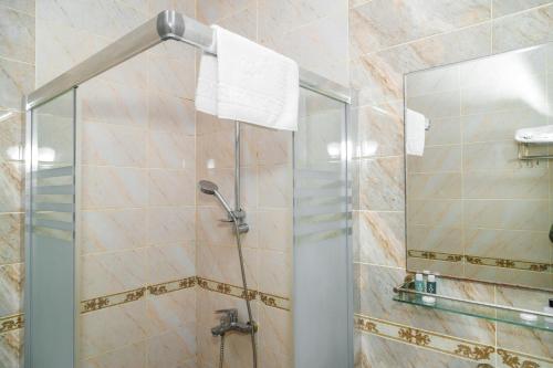 a shower with a glass door in a bathroom at Sahil Ark Hotel Baku in Baku