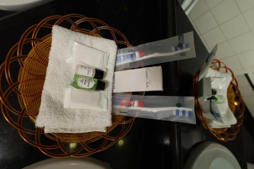 a basket with toiletries on a counter in a bathroom at Quaint Suites Hotel & Banquet in Mumbai