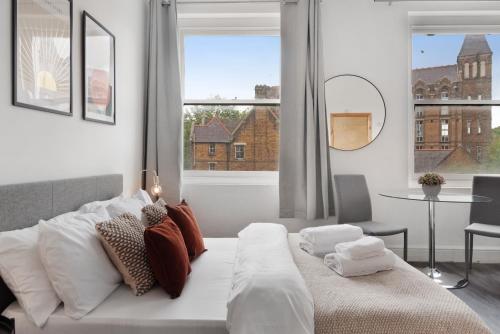 a bedroom with a bed and a large window at Archway Station Studios - Double bed in London