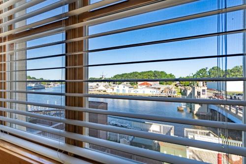 a window with a view of a river at Colonial 1 - studio apartment overlooking the Black River in South Haven