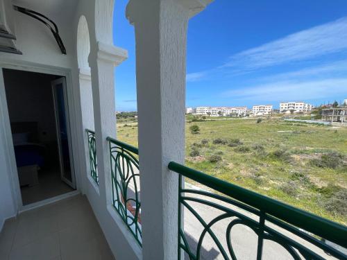 a balcony with a view of the beach and buildings at Appartement de vacances neuf: piscines et plage in Tangier