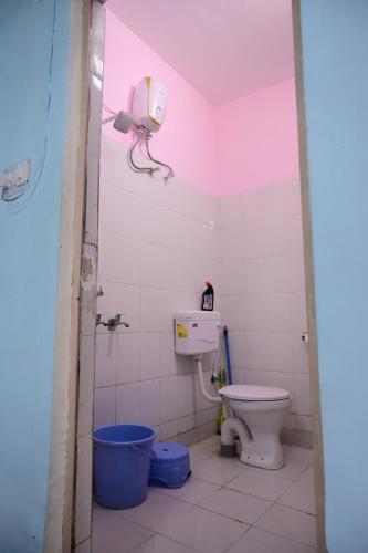 a bathroom with a toilet and a camera on the wall at Jankivihar Homestay at Prahladghat within 1km from Shri Ram Mandir in Ayodhya