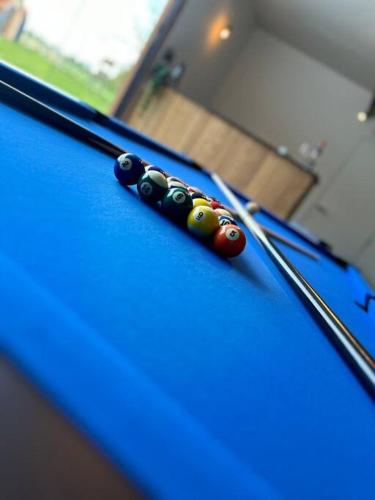two cue balls on top of a pool table at Vakantiehuis Laurine in Deinze