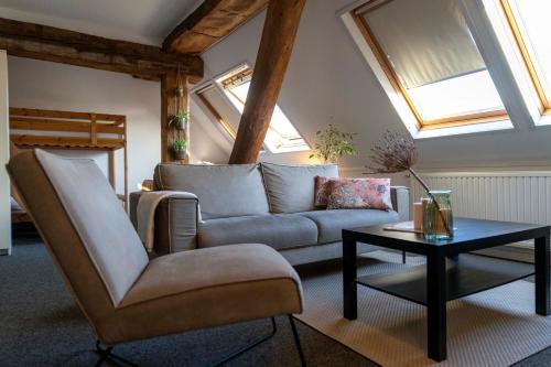 a living room with a couch and a table at Verblijf bij Bynt in Sneek