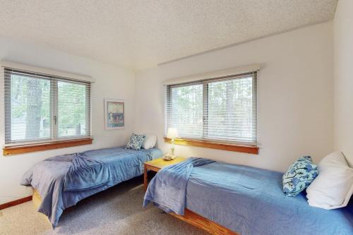 two beds in a room with two windows at Town of South Bethany --- 137 Evergreen Rd in South Bethany