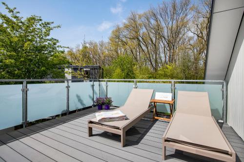 a balcony with two chairs and a table at Ferienhaus Schleibengel in Maasholm