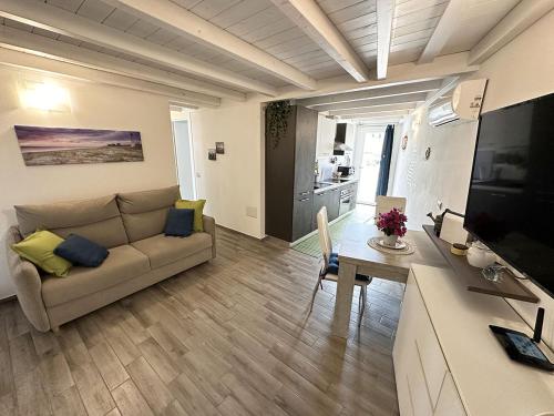 a living room with a couch and a table at Comodo e funzionale appartamento in pieno centro a Sant'Antioco C228 in SantʼAntìoco