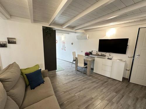 a living room with a couch and a table at Comodo e funzionale appartamento in pieno centro a Sant'Antioco C228 in SantʼAntìoco