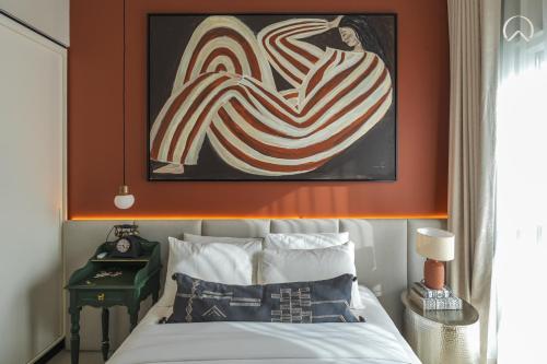 a bedroom with a bed with a painting above it at Oraya - Collective 2 0 Tower A Sanctuary in Dubai Hills in Dubai