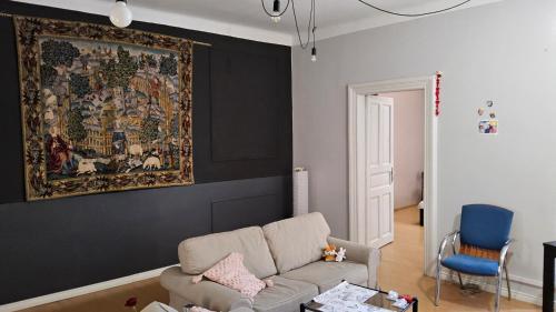 a living room with a couch and a tapestry at KRAKOW 1 in Krakow