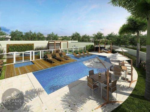 a swimming pool with chairs and a table next to it at Condominium SPAZIO BLU in Sao Jose do Rio Preto