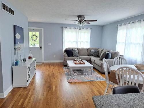 a living room with a couch and a table at School Street Haven - 4 bedroom 2 bath sleeps 10 and is centrally located to downtown South Haven in South Haven