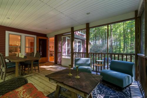 a screened in porch with a table and chairs at The Sanctuary - Halfway point between South Haven and Saugatuck - Walking distance to Lake Michigan in Glenn