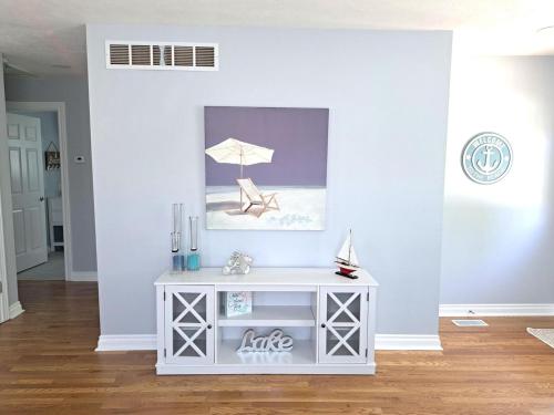 a white console table with a chair and an umbrella at School Street Haven - 4 bedroom 2 bath sleeps 10 and is centrally located to downtown South Haven in South Haven