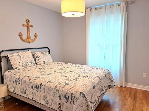 a bedroom with a bed with a anchor on the wall at School Street Haven - 4 bedroom 2 bath sleeps 10 and is centrally located to downtown South Haven in South Haven