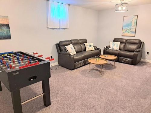 a living room with a couch and a chess board at School Street Haven - 4 bedroom 2 bath sleeps 10 and is centrally located to downtown South Haven in South Haven