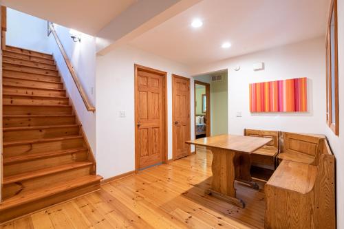 a home office with a wooden table and stairs at The Sanctuary - Halfway point between South Haven and Saugatuck - Walking distance to Lake Michigan in Glenn