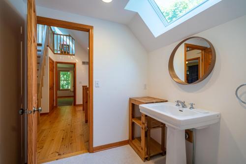 a bathroom with a sink and a mirror at The Sanctuary - Halfway point between South Haven and Saugatuck - Walking distance to Lake Michigan in Glenn