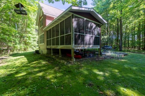 a house in the middle of a yard with trees at The Sanctuary - Halfway point between South Haven and Saugatuck - Walking distance to Lake Michigan in Glenn