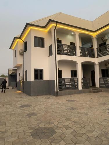 a man standing in front of a building at lnfinity Luxury Apartment in Abuja