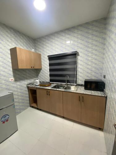 a kitchen with a sink and a counter top at lnfinity Luxury Apartment in Abuja