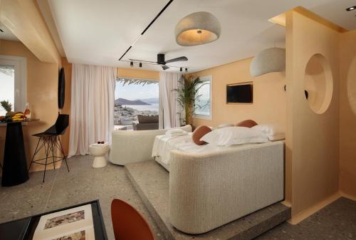 a bedroom with a bed and a living room at HIGH END Unique 270 degree aerial sea view suite in Naxos Chora