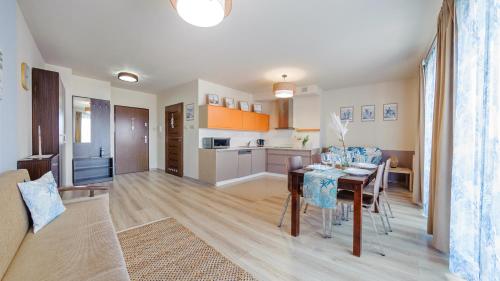 a kitchen and living room with a table and a dining room at Foka, Sun & Snow in Hel