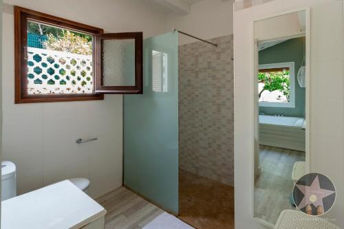 a bathroom with a shower with a glass door at VILLA GERMAN 114 sea views in Son Bou