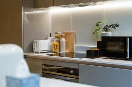 a kitchen with a counter top with a toaster oven at 2Bed House Twickenham With Private Garden in Twickenham
