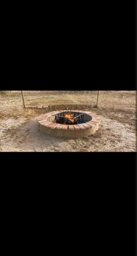 a fire pit in the middle of a field at Tienda acogedora con piscina "Amantes de la naturaleza" 1 in Almonte