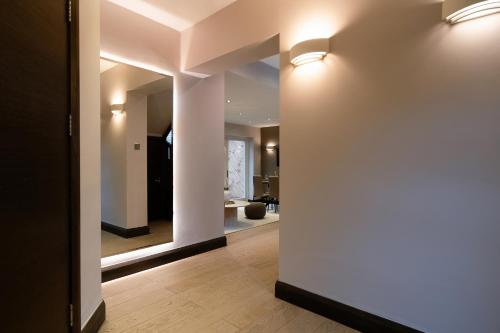 a hallway with two lights on a wall at Livestay 2Bed House in Twickenham Private Garden in Twickenham