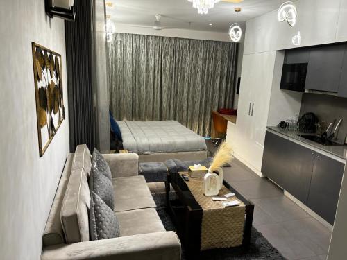 a living room with a couch and a bed at Luxury Heights with City View and River View in Noida