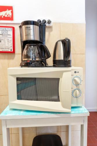 a microwave sitting on top of a table at Blife Faro Beach Hostel & Rooms in Faro
