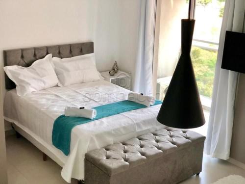 a bedroom with a bed and a large window at FLATS - DUO JK in Sao Jose do Rio Preto