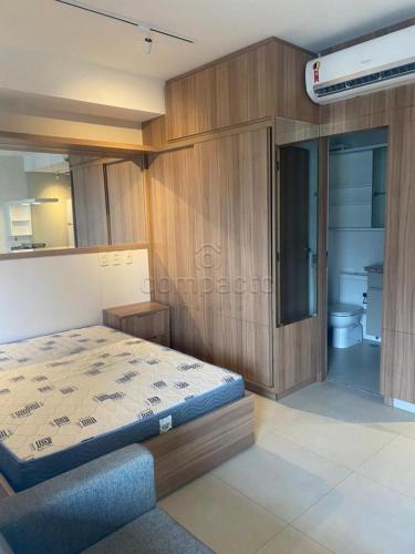 a bedroom with a bed and a bathroom at FLATS - DUO JK in Sao Jose do Rio Preto