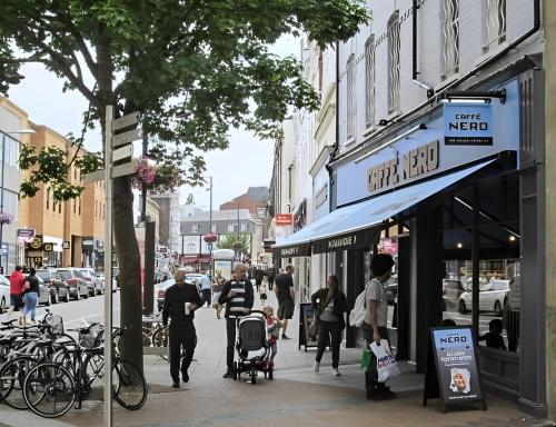 a busy city street with people walking on the sidewalk at New & Refurbished Central Kingston Studio in Kingston upon Thames