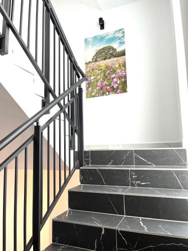 a stairway with a painting on the wall at Weißes Haus in Gerasdorf bei Wien