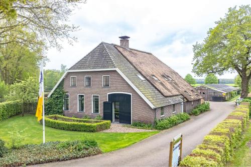 a large brick house with a gambrel roof at The blue lady in Sleen
