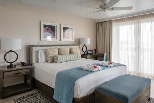 a bedroom with a bed with two stuffed animals on it at BodyHoliday St Lucia in Gros Islet