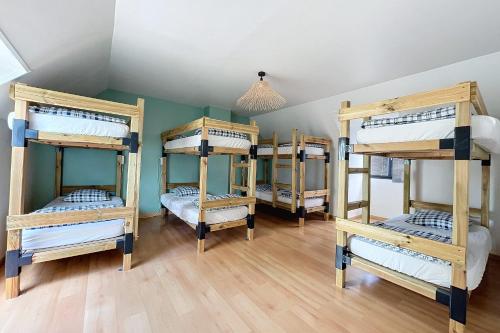 a group of bunk beds in a room at La Graviere - 28pers - swimming pool pétanque billiards in Fontenay-Trésigny