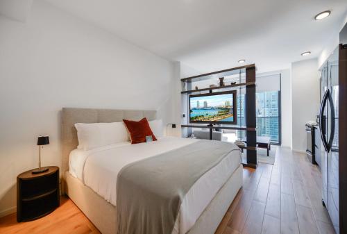 a bedroom with a large bed and a large window at Exquisite Bay View Studio at Downtown Miami in Miami